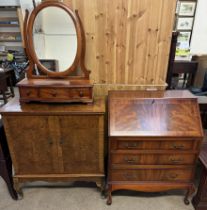 A reproduction mahogany bureau together with a walnut television cabinet and a dressing table