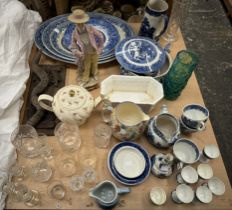 Blue and white pottery plates together with a continental porcelain figure, drinking glasses,