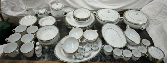 A Noritake part tea and dinner service decorated with a green and gilt border