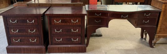 A reproduction mahogany dressing table together with a pair of matching bedside chests of drawers