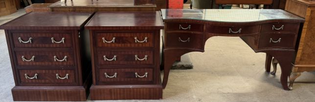 A reproduction mahogany dressing table together with a pair of matching bedside chests of drawers