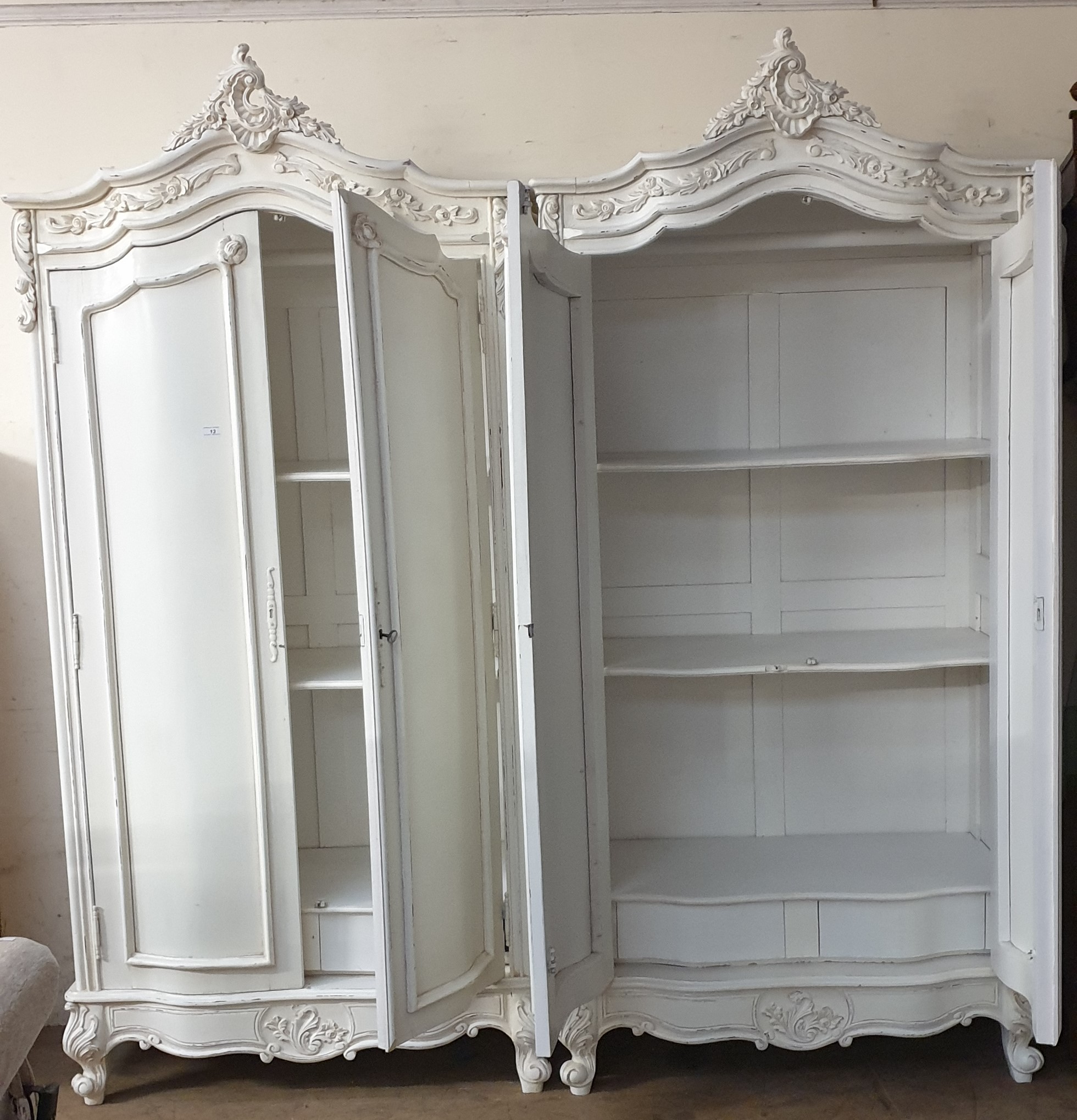 A pair of cream painted armoires with carved cresting and a pair of cupboard doors on leaf carved - Image 4 of 4