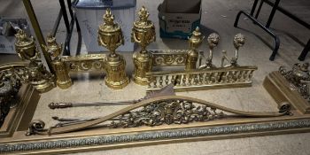 A brass fire fender with urn ends together with a pierced fire fender, brass andirons,