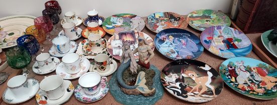 A collection of Cartoon Classics collectors plates together with an Enchantica figure of a Merman