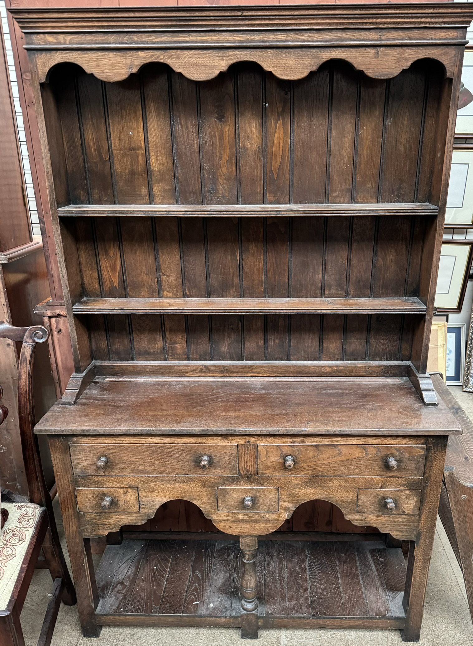 A 20th century oak dresser with a moulded cornice above two shelves,