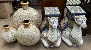 A pair of pottery garden seats in the form of camels together with a set of three graduated vases