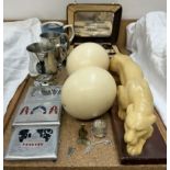 Two ostrich eggs together with a resin tiger, tankards, cigarette cases,
