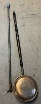 An antler handled walking stick together with another walking stick and a bed warming pan