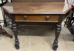 A mahogany side table with a moulded top above a frieze drawer on turned legs