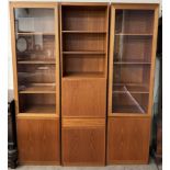 A mid 20th century teak wall unit in three sections with glazed and cupboard doors,
