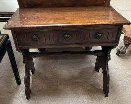 A 20th century mahogany side cabinet with a hinged lid above a carved front on slab sides