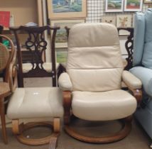 An upholstered swivel chair together with a footstool