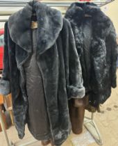 A black fur jacket together with a faux fur coat