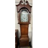 A 19th century oak longcase clock the hood with a broken swan neck pediment and turned columns,