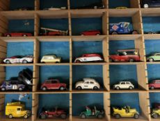 A collection of corgi and other model cars in a sectional shelf unit together with a boxed Corgi