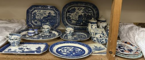 Blue and white willow pattern meat plates together with other blue and white pottery, tiles,