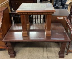 A reproduction mahogany coffee table with a rectangular top and inlaid glass panel on square legs