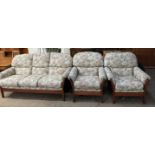 A modern teak floral upholstered three piece suite
