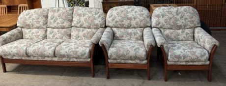 A modern teak floral upholstered three piece suite
