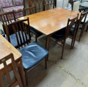 A mid 20th century teak dining table and six chairs with a slat back and upholstered seats
