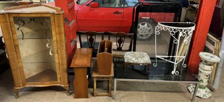 A 20th century walnut standing corner cupboard with a glazed door together with magazine racks,