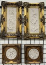 A pair of reconstituted marble plaques of figures and cherubs together with a pair of smaller