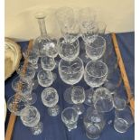 Assorted crystal wine glasses together with a decanter and other glasses