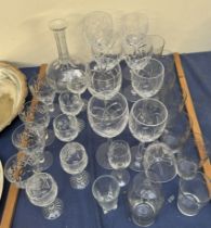 Assorted crystal wine glasses together with a decanter and other glasses