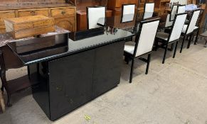 A Pierre Vandel high gloss black dining table together with eight chairs and a matching sideboard