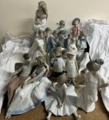 A collection of Nao figures including a mother and child, wedding couple, children,