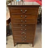 A mahogany music cabinet with a rectangular dentil moulded cornice above eight drawers with drop