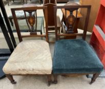A pair of Edwardian inlaid mahogany nursing chairs with upholstered seats on square tapering legs