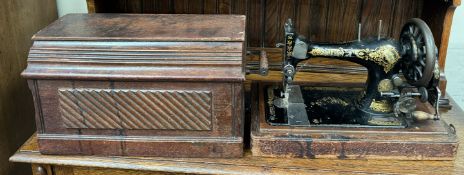 A Singer sewing machine in an oak case