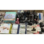 A collection of postcards together with an assortment of cameras etc