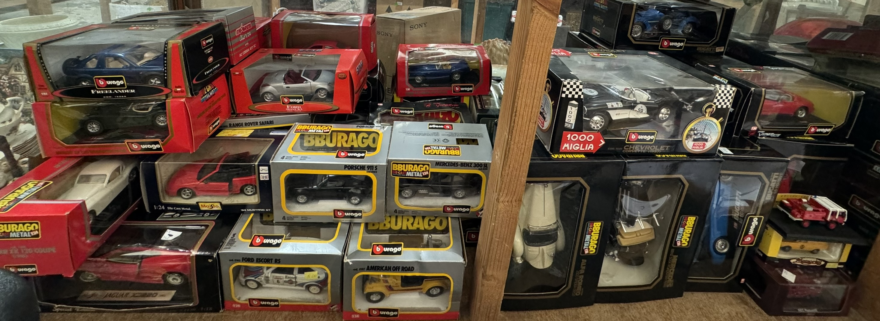 A large collection of Burago and other model cars including Ford AC Cobra 427, Ford Street Ka,