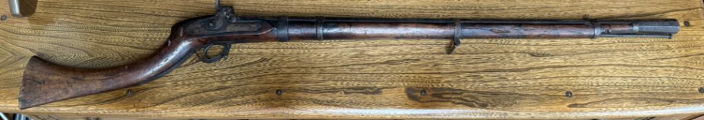 A percussion rifle with a flared octagonal barrel and ramrod,