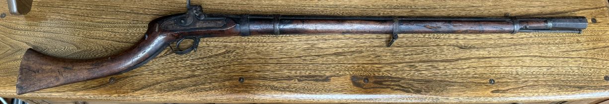 A percussion rifle with a flared octagonal barrel and ramrod,