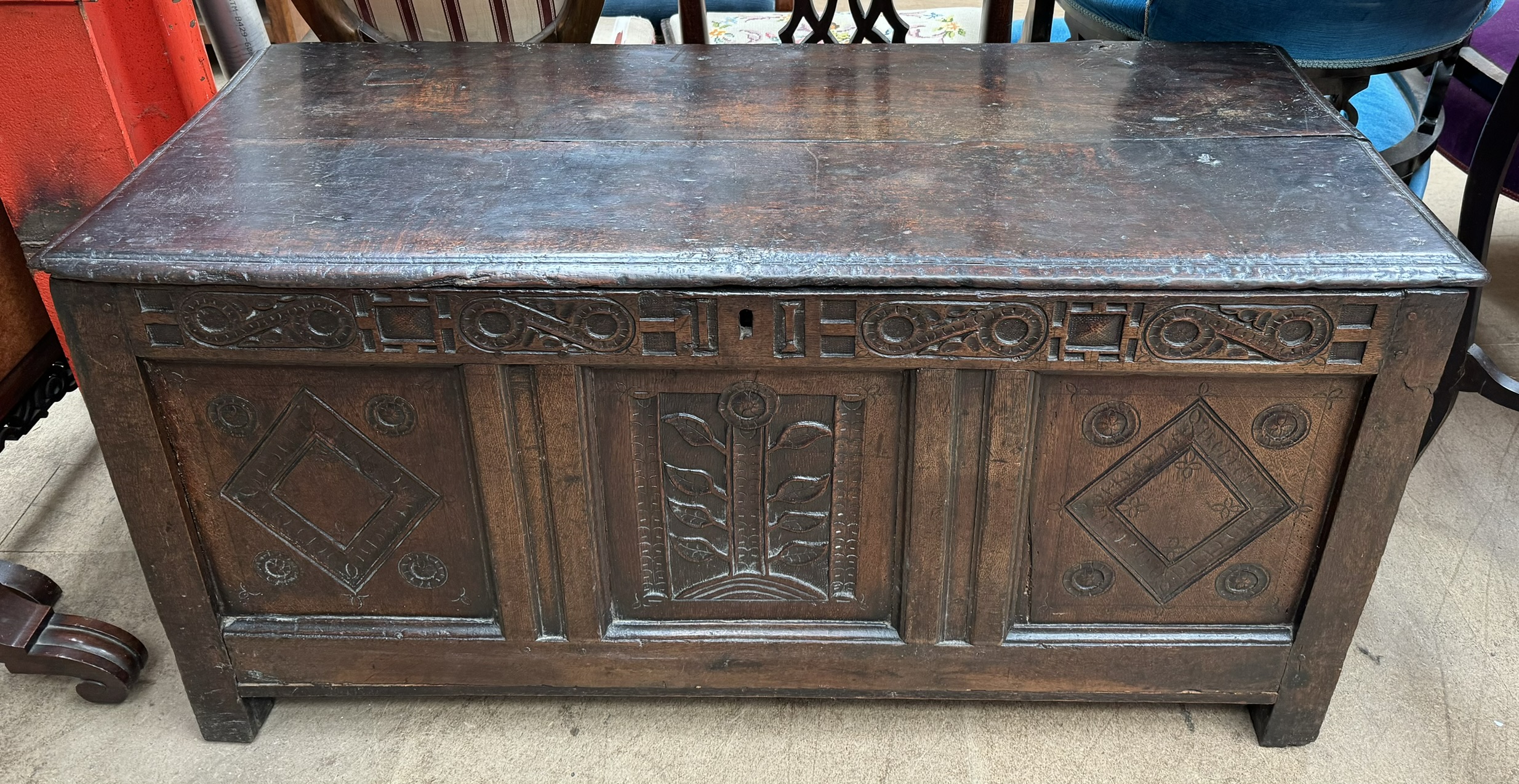 A late 17th / early 18th century oak coffer with a planked rectangular hinged top above a carved