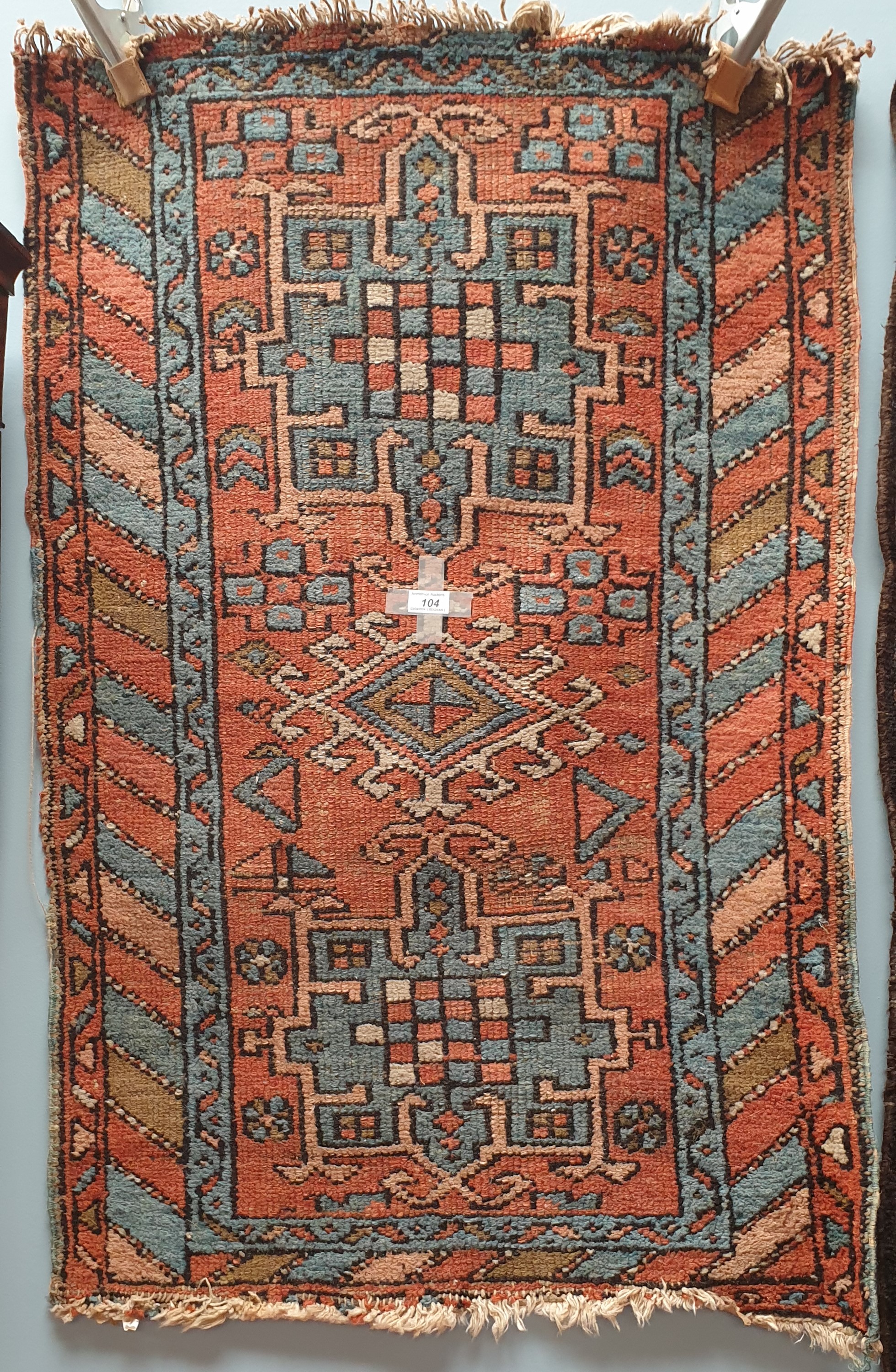 A rug with a blue ground decorated with two medallions and stars to multiple guard stripes,