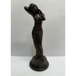 A bronzed figure of a maiden on a turned base