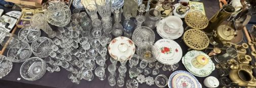 An extensive lot including drinking glasses, glass bowls, glass jugs, pottery plates,