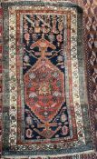 A rug with a blue ground, the centre with a red ground medallion and multiple guard stripes,