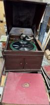 An HMV table top gramophone and records