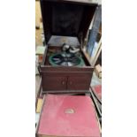 An HMV table top gramophone and records