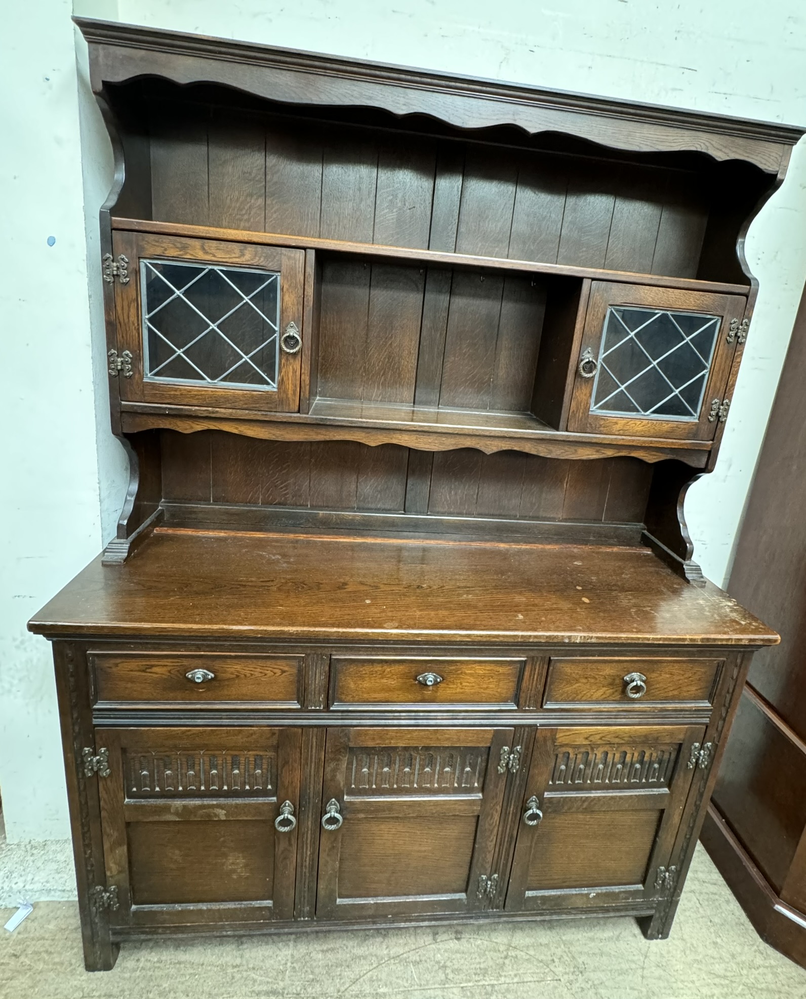 A 20th century oak dresser, the top with shelves and glazed cabinets,
