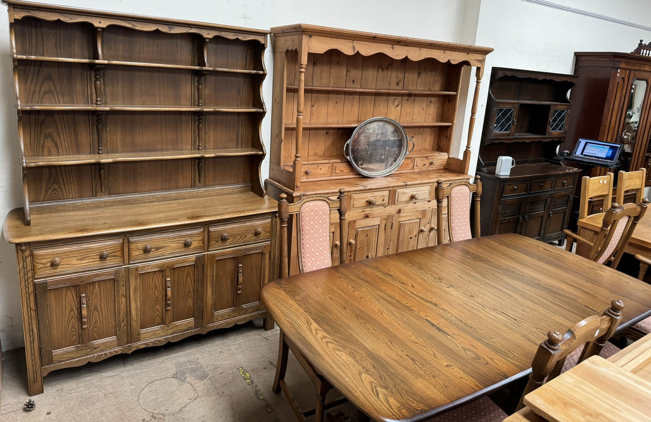 An Ercol dining suite comprising an extending dining table,