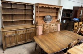 An Ercol dining suite comprising an extending dining table,