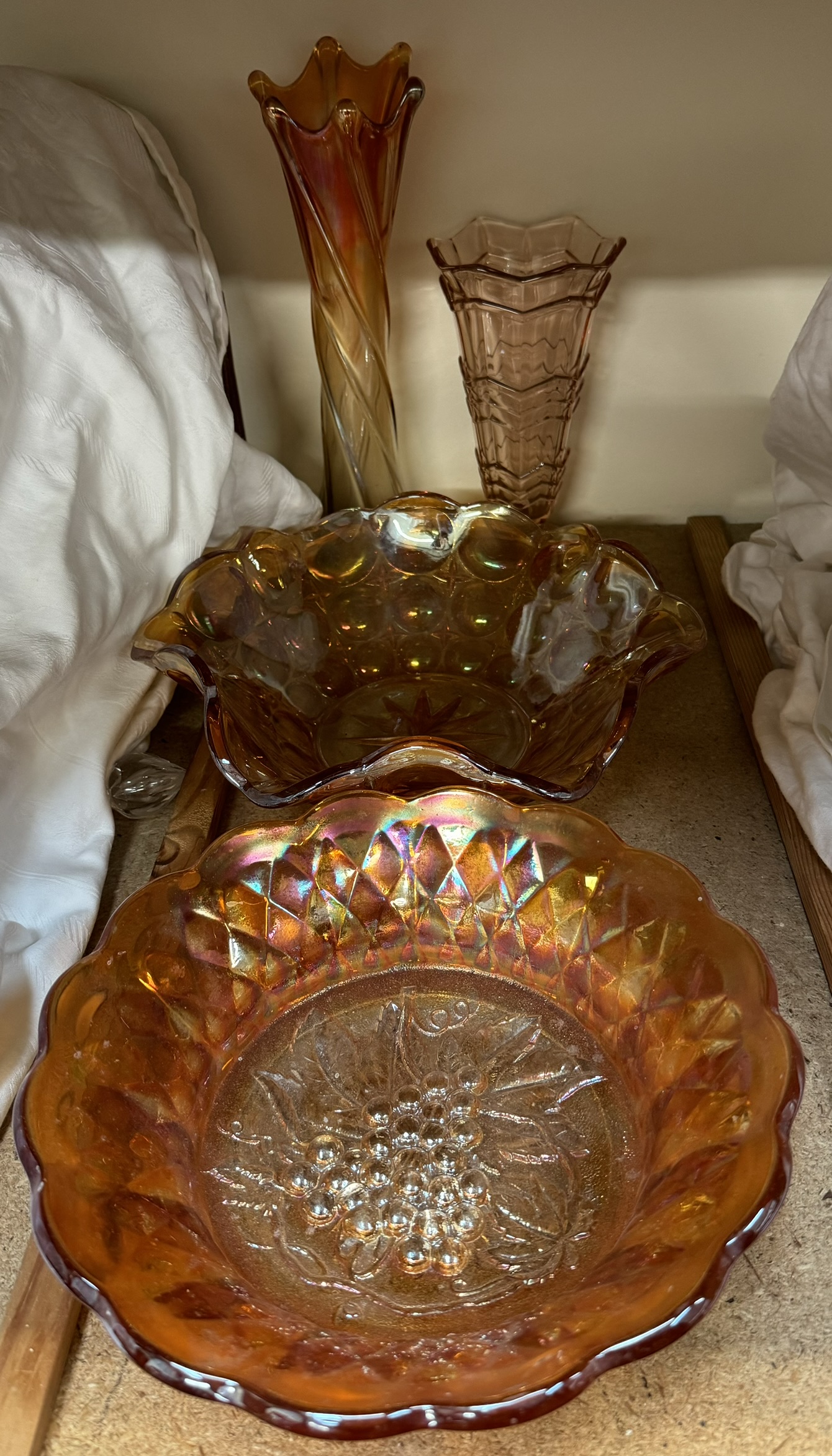 A carnival glass bowl moulded with grapes to the base together with a lustre glass bowl and two