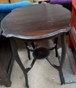 A mahogany occasional table with a shaped circular top on four square legs united by an undertier