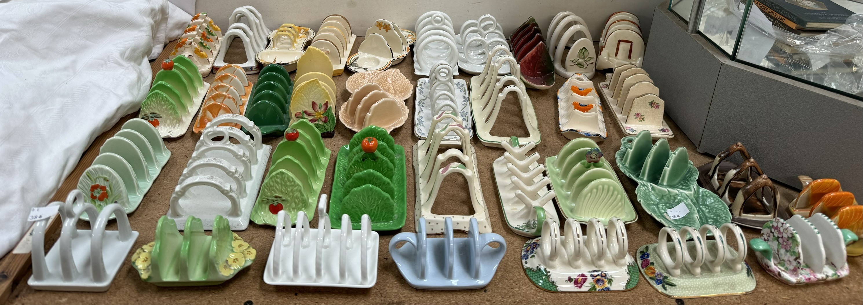 A collection of pottery toast racks including Crown Devon, Sylvac, Burleigh Ware,